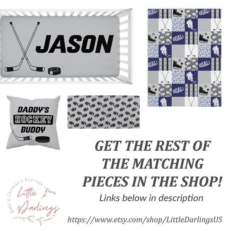 May include: A personalized baby crib bedding set with a hockey theme. The set includes a fitted sheet with the name "JASON" printed in black, a pillow with the text "DADDY'S HOCKEY BUDDY", a patterned crib sheet with hockey pucks, and a quilt with a patchwork design featuring hockey sticks, pucks, and the word "GOAL".