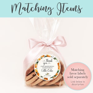 May include: A clear cellophane bag filled with cookies tied with a pink ribbon and a round thank you sticker with orange and green floral designs. The sticker says "thank you" for showering Samantha's Little Cutie, 02-18-2023.