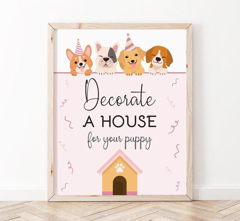 May include: A pink and white printable sign with four cartoon dogs wearing party hats. The sign says "Decorate a house for your puppy" and has a cartoon dog house with a paw print on the roof.