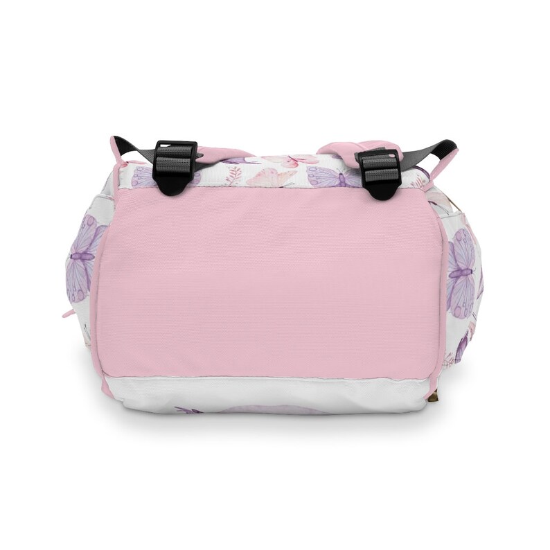 May include: A pink and white backpack with a butterfly pattern. The backpack has adjustable straps and a zip closure.