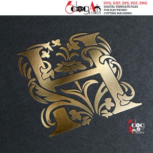 May include: Gold metallic letter H with ornate floral designs. The letter is on a dark gray background.