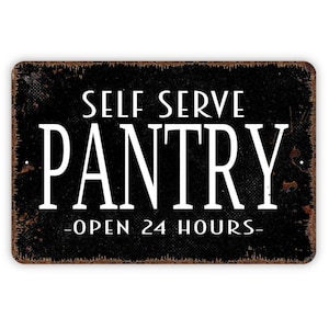 May include: A rectangular metal sign with a black background and distressed rust-colored edges. The white text reads SELF SERVE PANTRY in large letters, with OPEN 24 HOURS centered below. The sign features two small mounting holes on the left and right sides.