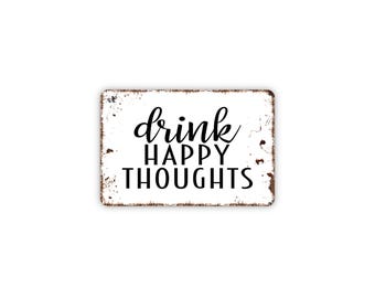 May include: A rectangular white metal sign with rounded corners and a distressed, rusted edge finish. The sign features the black text "drink" in a cursive script font, followed by "HAPPY THOUGHTS" in a bold, sans-serif, uppercase font.