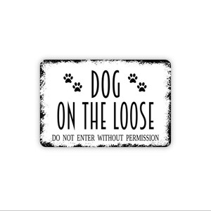 May include: A rectangular white sign with a distressed black border featuring the black text DOG ON THE LOOSE and DO NOT ENTER WITHOUT PERMISSION. Four black paw prints are positioned around the main text on this warning sign.