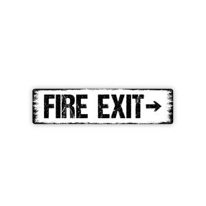 May include: A rectangular sign with the words "FIRE EXIT" in bold, black letters. An arrow points to the right. The sign has a distressed, vintage look with a white background and black border.