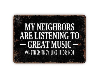 May include: A rectangular metal sign with a distressed black finish and rust-colored edges. The white text reads: MY NEIGHBORS ARE LISTENING TO GREAT MUSIC WHETHER THEY LIKE IT OR NOT. The sign features a weathered texture and rounded corners.