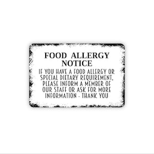 May include: A rectangular white sign with a distressed black border featuring the text FOOD ALLERGY NOTICE. The text reads: IF YOU HAVE A FOOD ALLERGY OR SPECIAL DIETARY REQUIREMENT, PLEASE INFORM A MEMBER OF OUR STAFF OR ASK FOR MORE INFORMATION - THANK YOU.