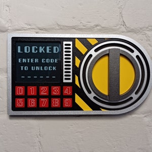 May include: A silver and black combination lock with a yellow and black striped design. The lock has a digital display that reads "LOCKED ENTER CODE TO UNLOCK" and a keypad with the numbers 0-9.