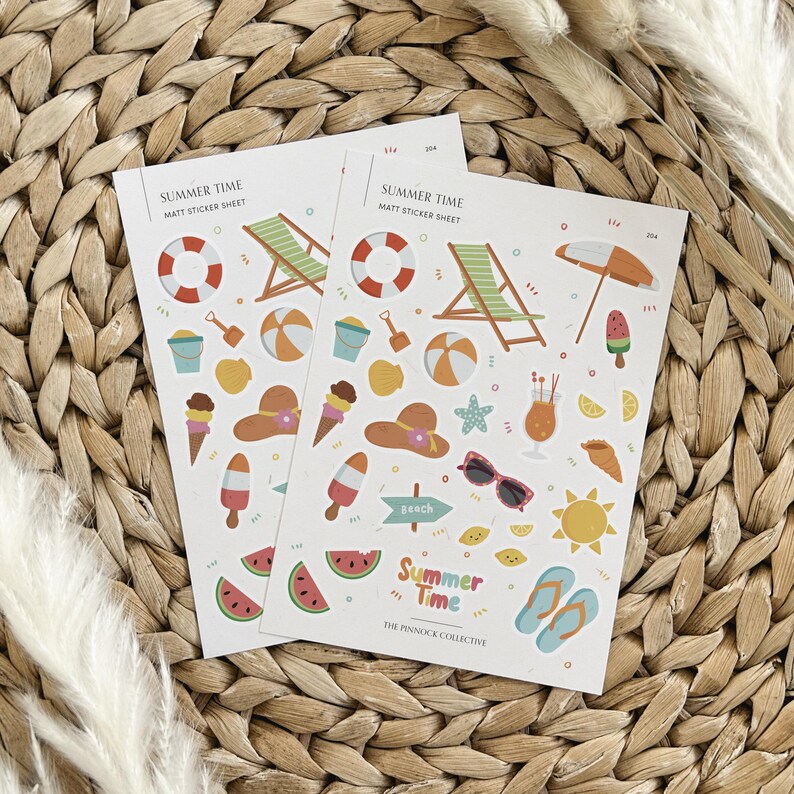 May include: A sheet of summer-themed stickers with a white background. The stickers feature various summer icons, including a beach chair, a beach umbrella, a watermelon, a beach ball, a life preserver, a popsicle, a sun, a pair of sunglasses, a seashell, a starfish, a lemon, a cocktail, a bucket and shovel, ice cream cones, a hat, and a sign that says "Beach". The text "Summer Time" is printed at the top of the sheet, along with the text "The Finnock Collective".