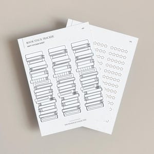 May include: Two white sticker sheets with black line drawings. One sheet features stacks of books, labeled "BOOK STACK TRACKER." The other sheet has star-shaped stickers for rating books. The text "THE PINNOCK COLLECTIVE" is at the bottom of the book tracker sheet.