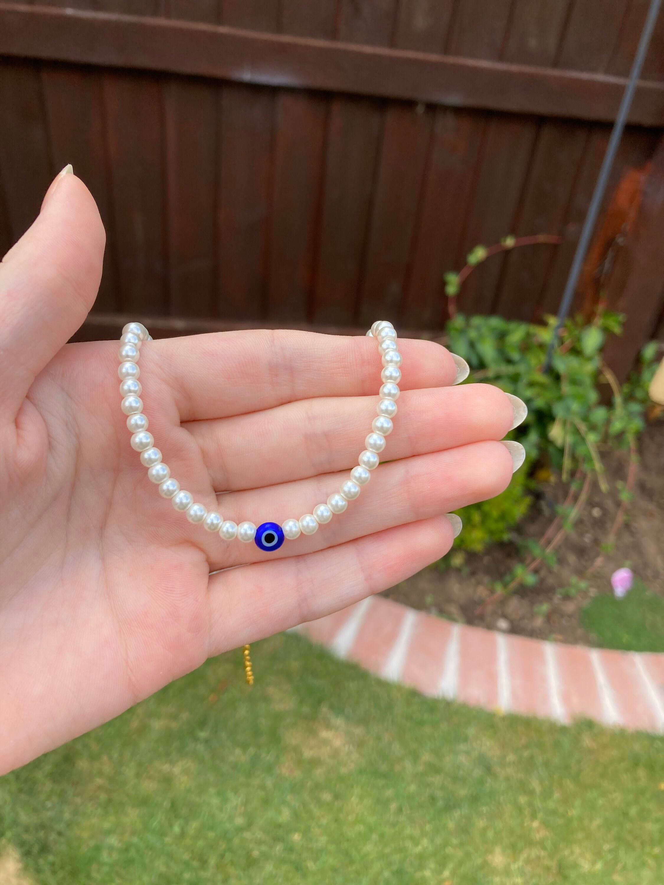 Pearl necklace with evil eye charm 