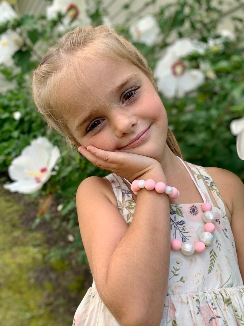 Soft pink & Pearl silicone necklace beads and stretch bracelet beautifully bundled as a set, perfect for dressing up. Kids love the ability to adorn themselves with jewelry, and our durable double threaded elastic helps them with independently play!