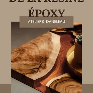 Puede incluir: Primer plano de una mesa de madera con una incrustación de resina epoxi marrón. La mesa presenta un patrón de vetas de madera natural con un tono cálido marrón rojizo. El texto en la imagen dice "L'ULTIME GUIDE LES SECRETS DE LA RÉSINE ÉPOXY ATELIERS DANELEAU."