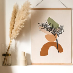 May include: A framed print with an abstract design of a stylized plant with brown, orange, and green shapes. The print is hanging on a white wall above a framed print with a sunburst design in shades of orange and brown.
