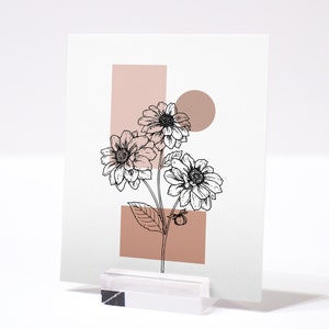 May include: A printable art print featuring a black and white line drawing of a bouquet of flowers with a pink and white geometric background.