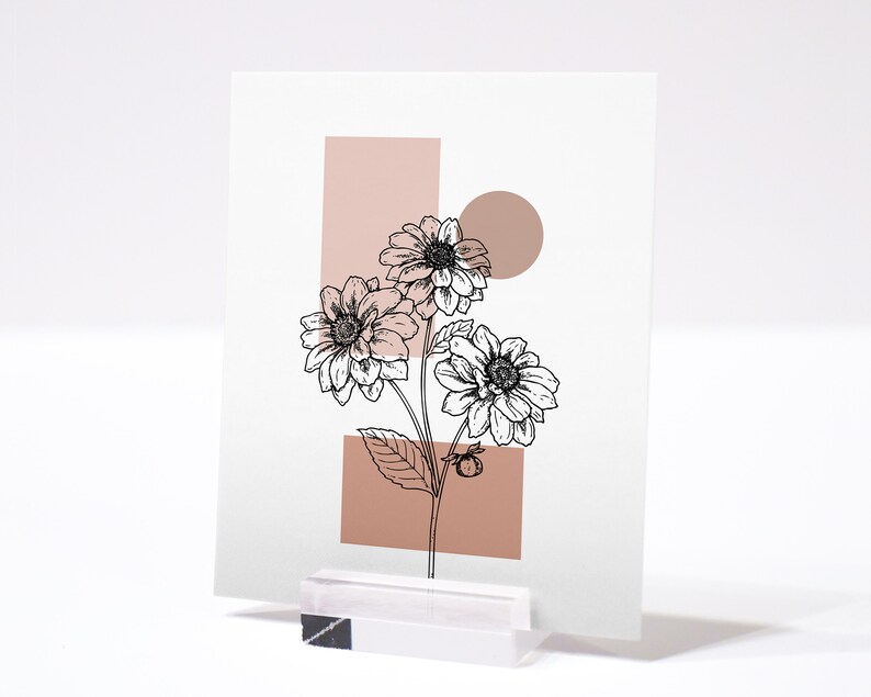 May include: A printable art print featuring a black and white line drawing of a bouquet of flowers with a pink and white geometric background.
