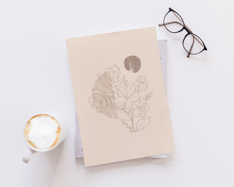 May include: A beige print with a line drawing of a bouquet of flowers in a circle with a brown watercolor background.