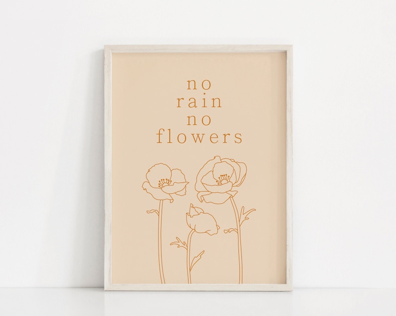May include: A beige printable art print with a white frame. The print features a minimalist line drawing of three flowers with the text "no rain no flowers" in brown.