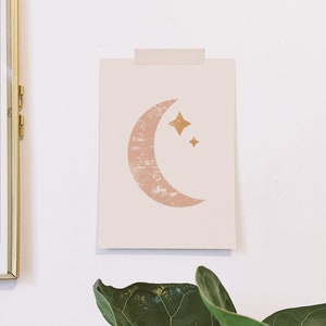 May include: A printable art print featuring a pink crescent moon with a textured surface and two gold stars. The print is on a white background.