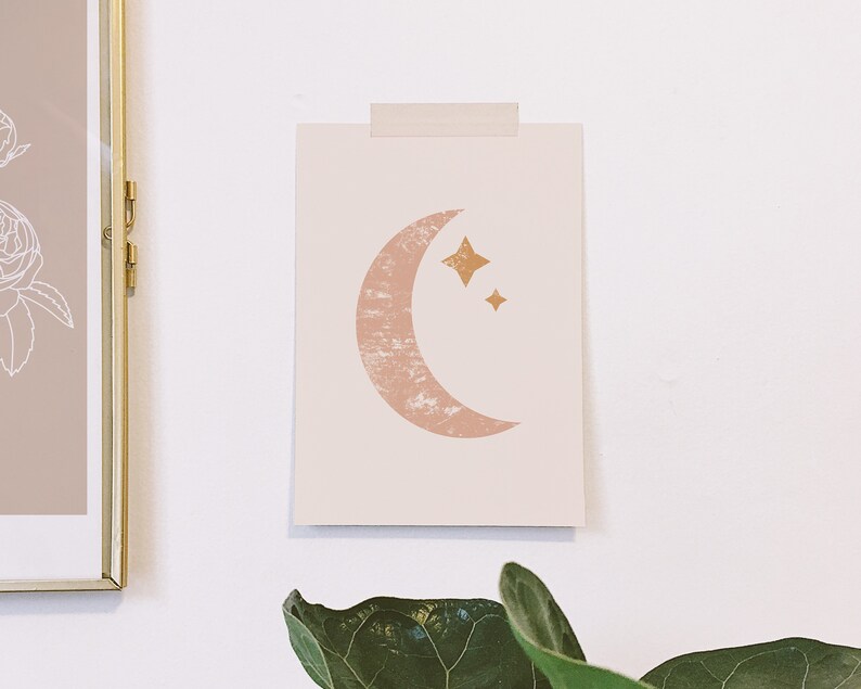 May include: A printable art print featuring a pink crescent moon with a textured surface and two gold stars. The print is on a white background.