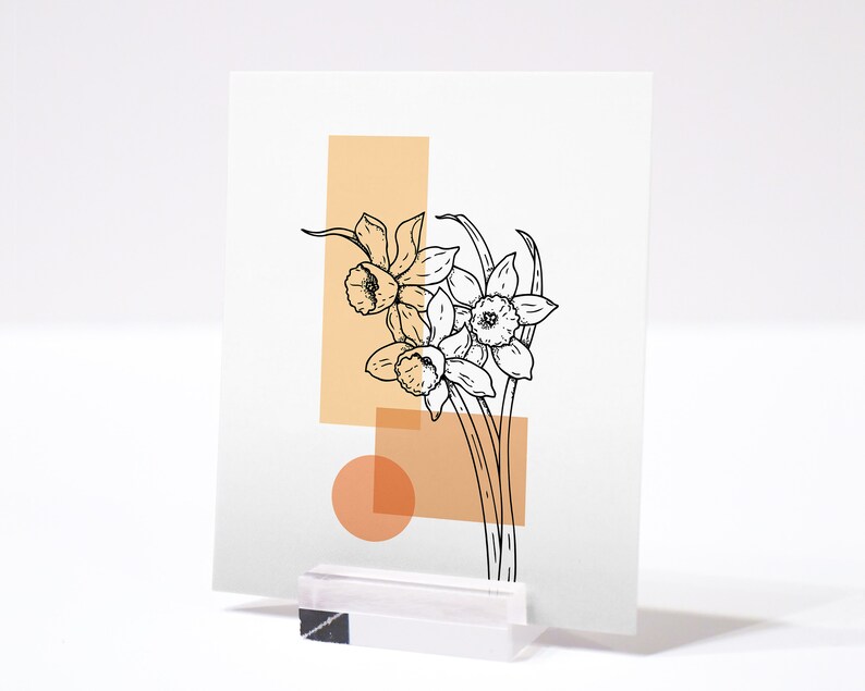 May include: A minimalist art print featuring a line drawing of daffodils in black against a background of peach and cream colored geometric shapes.