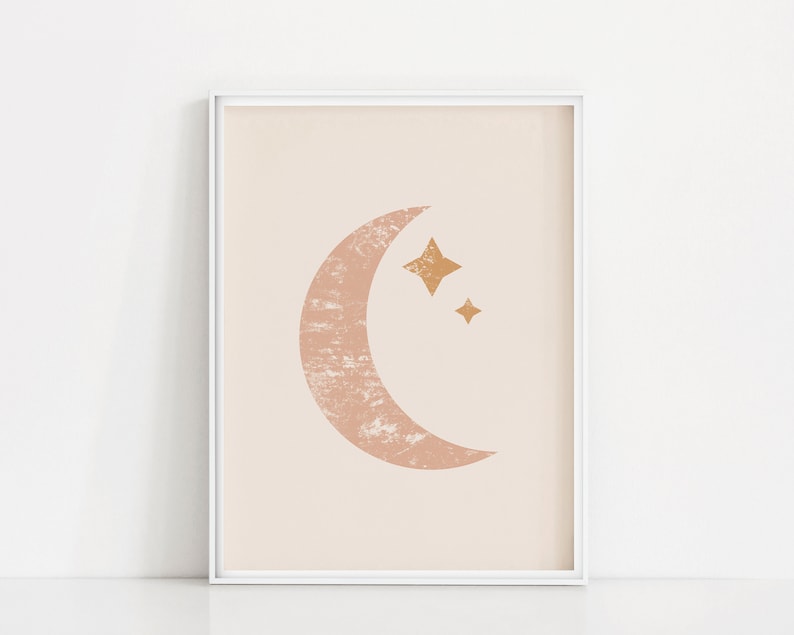 May include: A framed print featuring a pink crescent moon and gold stars on a pale pink background.
