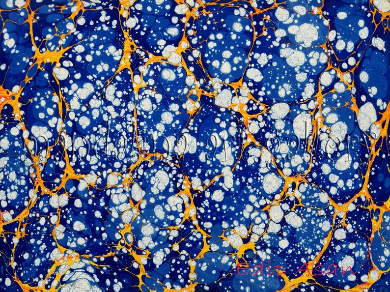 May include: Abstract marbled paper with a blue background, white and gold swirls, and white dots.