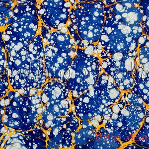 May include: Abstract marbled paper with a blue background, white and gold swirls, and white dots.