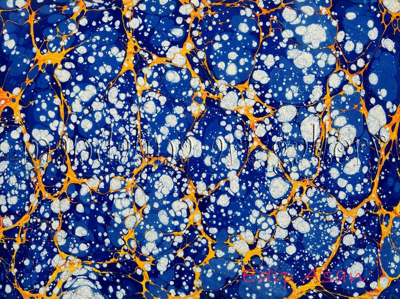 May include: Abstract marbled paper with a blue background, white and gold swirls, and white dots.