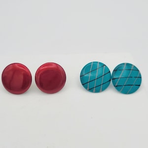 May include: A set of four earrings, two are solid red and two are turquoise with black lines.