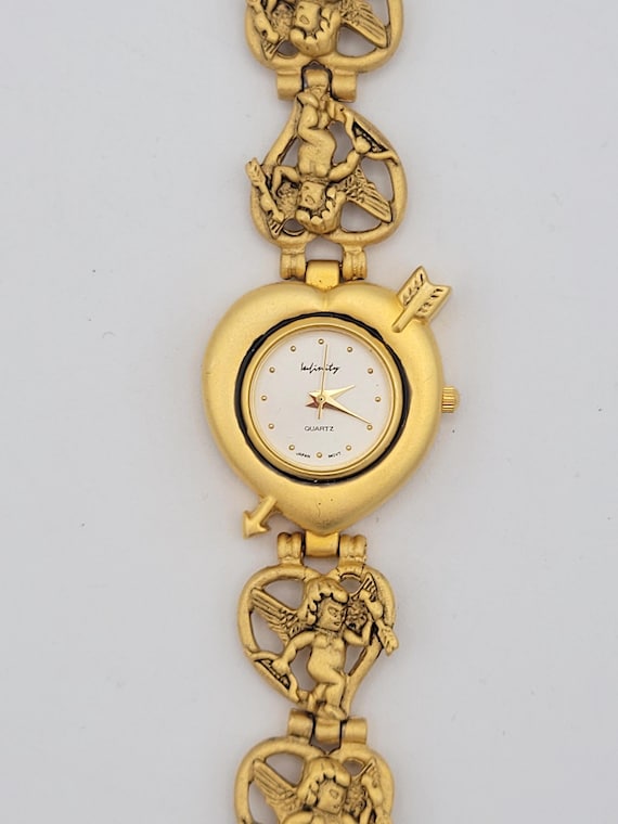 Vintage Infinity Matte Gold Tone Openwork Cupid & Heart Bracelet Watch Costume Jewelry Statement Women Timepiece Brushed Bow and Arrow