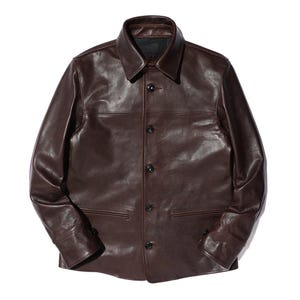 May include: A dark brown leather jacket with a classic collar and button-up front. The jacket features two front pockets and long sleeves. The leather has a slightly textured appearance.