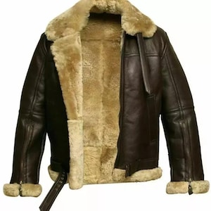 May include: A brown leather bomber jacket with a shearling collar and lining. The jacket has a zip fastening and two pockets on the front.