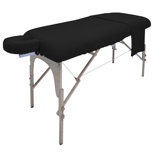 May include: A black massage table with wooden legs and a black fitted sheet. The table has a face cradle and adjustable height.