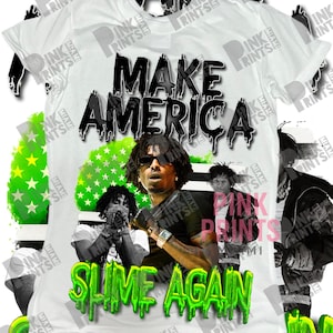 May include: White t-shirt with the text "MAKE AMERICA" in black dripping font. The shirt features a graphic of a person and the text "SLIME AGAIN" in green dripping font. The background includes a green and white American flag design.