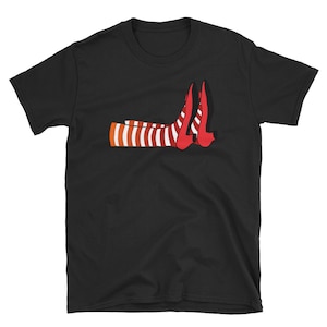 Könnte beinhalten: Schwarzes T-Shirt mit einem Motiv von rot-weiß gestreiften Beinen, die rote Schuhe mit spitzen Zehen tragen.