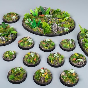 May include: A collection of miniature terrain bases, featuring various sizes and shapes. Each base is meticulously detailed with realistic-looking green foliage, small rocks, and colorful flowers. The bases are designed for tabletop gaming and miniature wargaming.