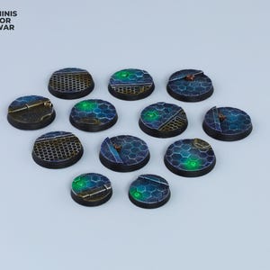 May include: Twelve round, black and blue plastic bases with a green glow. The bases have a hexagonal pattern and are designed for miniature wargaming.