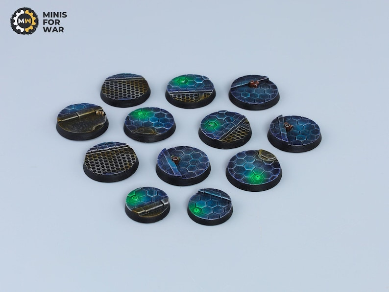 May include: Twelve round, black and blue plastic bases with a green glow. The bases have a hexagonal pattern and are designed for miniature wargaming.