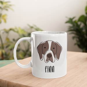 May include: White ceramic mug featuring a brown and white dog illustration with the name "Finn" printed on the front.