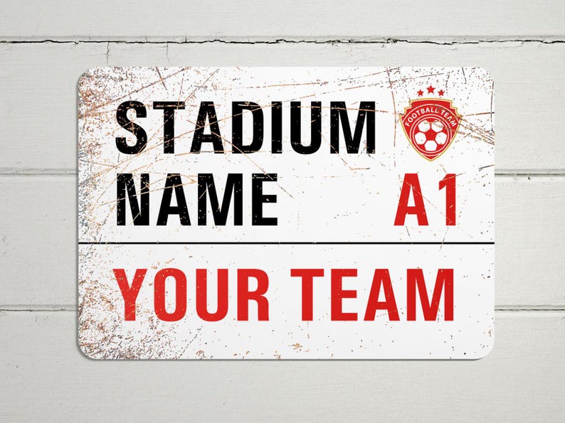 May include: White metal sign with a distressed look. The sign says "Stadium Name A1 Your Team" with a red soccer ball logo in the top right corner.