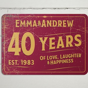 May include: A red metal sign with a distressed finish. The sign reads "Emma & Andrew 40 Years of Love, Laughter & Happiness Est. 1983".