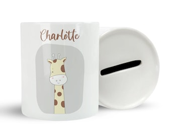 May include: White ceramic money box with a slot on the top. The front of the box features a cartoon giraffe with brown spots on a grey background. The name "Charlotte" is written in brown text above the giraffe.