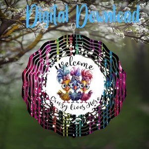 May include: A decorative wind spinner with a colorful design. The center features three cartoon chickens with the words "welcome crazy lives here." The background has a black and white striped pattern with pink, green, and blue accents. The text "Digital Download" is at the top.