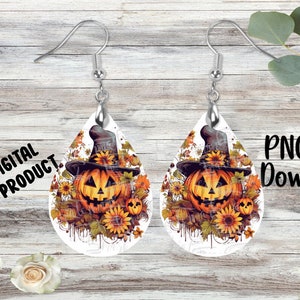 May include: A pair of teardrop-shaped earrings featuring a graphic print of a jack-o'-lantern wearing a witch hat, surrounded by sunflowers and autumn leaves. The earrings have silver-toned metal fishhook wires for pierced ears.