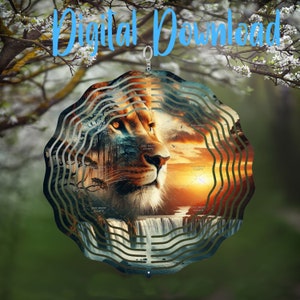 May include: A metal wind spinner with a circular design featuring a lion's face and a waterfall. The lion's face is in the center of the spinner, with the waterfall cascading down behind it. The background is a sunset with orange, yellow, and red hues. The spinner is made of metal and has a silver finish.