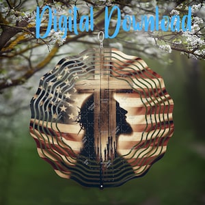 May include: A metal wind spinner with a silhouette of Jesus on the cross. The cross is made of wood and the background is an American flag. The wind spinner is hanging from a tree branch.