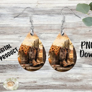 Op de afbeelding: Druppelvormige oorbellen met een rustiek ontwerp met cowboylaarzen, zonnebloemen en een houten hek. De oorbellen hebben zilverkleurige haken. De woorden "DIGITAL PRODUCT" en "PNG File Download" zijn zichtbaar.