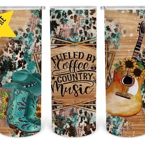 May include: Three different designs for a tumbler featuring a country music theme. The first design features a pair of turquoise cowboy boots with sunflowers. The second design features the text "Fueled by Coffee & Country Music". The third design features a brown acoustic guitar with sunflowers.