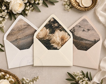 May include: Three open envelopes with decorative liners. The left liner features a textured landscape, the center liner displays large white peonies on a dark background, and the right liner shows a vintage-style scene of birds flying over a field.